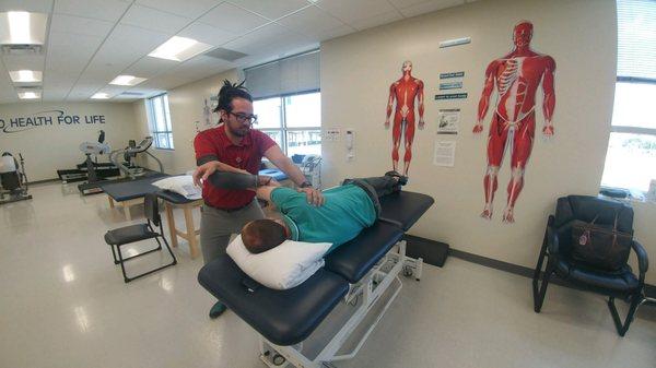 Physical therapist performing manual therapy techniques.