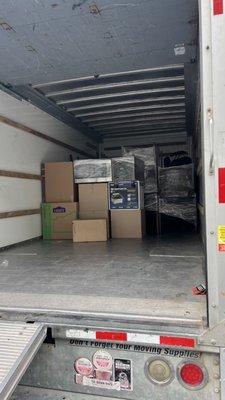 Carefully stacking and stripping items inside truck