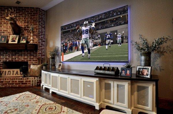 Ultra short throw projector and 110" screen in fully lit family room, projector is in the cabinet below screen!