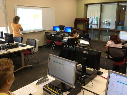 A MAM Employment Services volunteer teaches MS Excel to MAM clients in our 15-station computer lab.