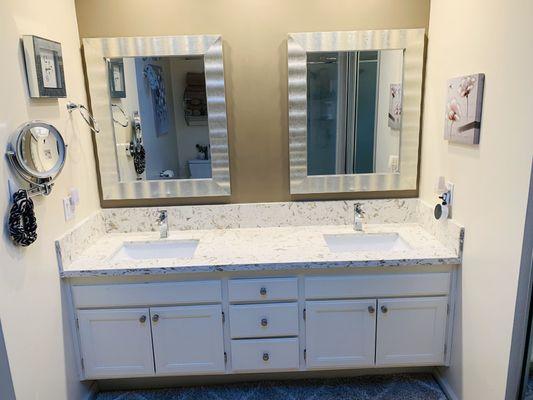 Quartz countertop with two under mount sinks.