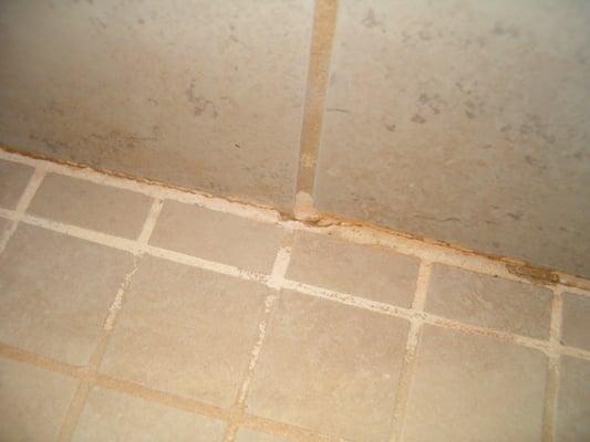 just a few months later...cracked and sloughed off grout You can see the very bad discoloration from wrong chemical for the type of grout.