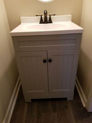 New 24" wide vanity with granite top and bronze faucet