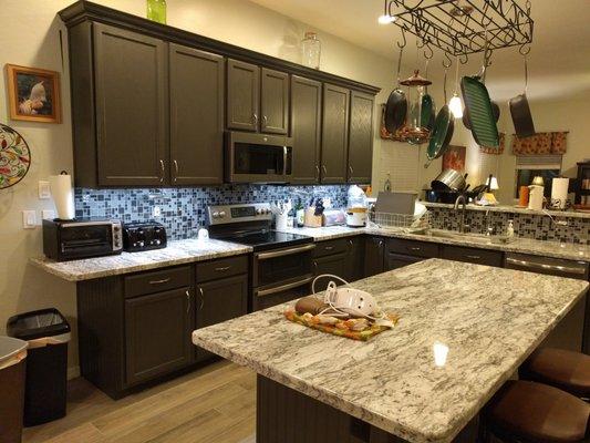 Backsplash, counters, and floors by Optimum - - - We're happy!