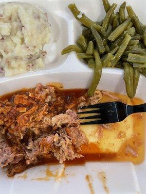 BBQ drenched in vinegar concoction with overcooked green beans.