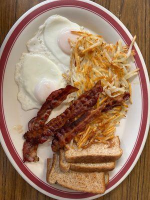 Eggs, hash browns, bacon, and toast.