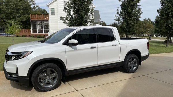 Two front windows tinted and windshield banner.