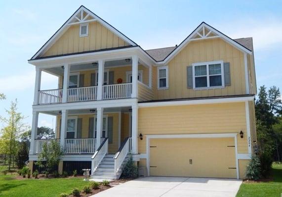 The unique soft yellow color on the James Hardie Siding styles this Charleston, SC home nicely!