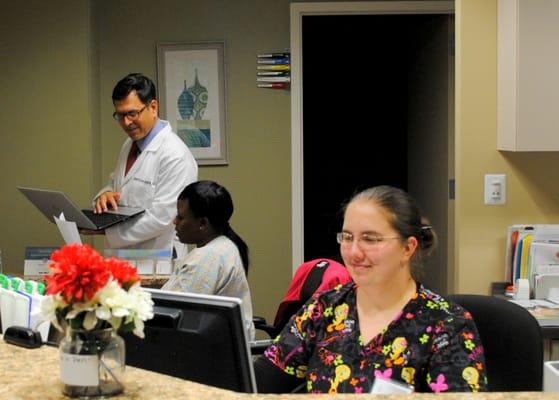 Dr. SInha working with Latoya and Laura