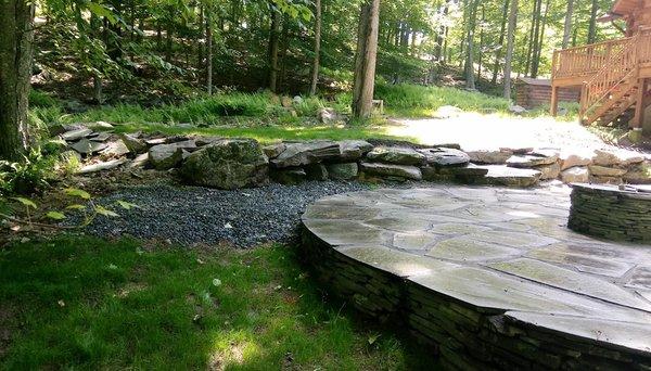 Boulder retaining wall and repair of bluestone patio