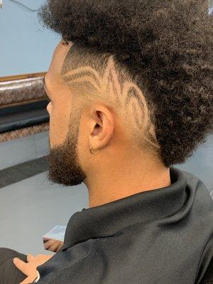 Custom hair design, mid-fade, and taper. Curly haircut.