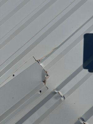 Damaged metal roof by installers