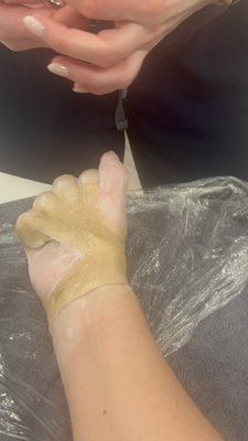 Binding into fist, dip in wax, remain under protective layers and heat