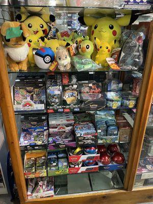 Deck boxes, Mini Tins, poke ball, and plush