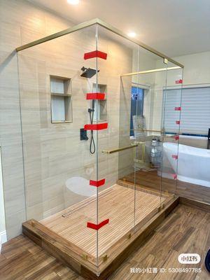 Three Sided Glass Frameless shower door with square Satin Brass Hardware and Starphire Glass.