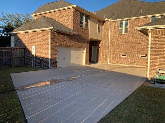 Residential hardscape service: Brush scrubbed brick entry, sidewalks, driveway, garage parking, curbs & street gutter.