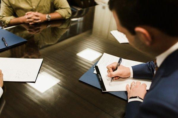 Attorney, Landon Long during a signing with Clients