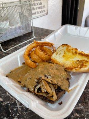 Hamburger Steak "all the way" served up for this customer with a few onion rings and bread