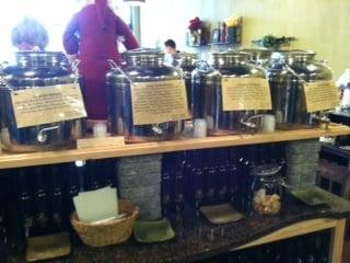 The stainless steel jugs with bread and small cups for sampling