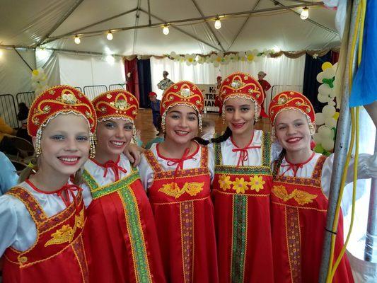 Romashka Dance Ensemble girls are waiting while boys on stage