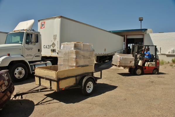 Loading pallets in my trailer for the last five miles of their journey.