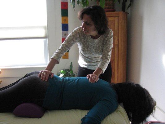 Bodywork: Rocking the sacrum relaxes and brings energy flow through out the spine.