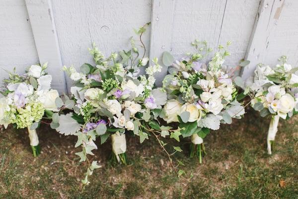 Bride and attendant bouquets for an outdoor barn wedding. 
 Photo courtesy of Lauren Fair Photography.