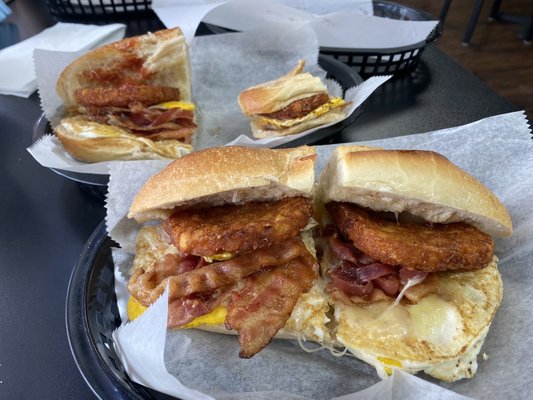 Bacon egg and cheese on a long roll-with a hash brown on top.