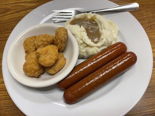 Hot Dog Special; jumbo-sized, comes with sauerkraut. I opted for corn fritters. Brown gravy added for the mashed potatoes.