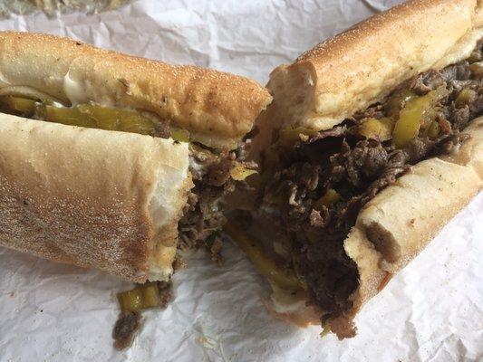 Cheesesteak with hot peppers. Liscios roll, American cheese  solid sandwich