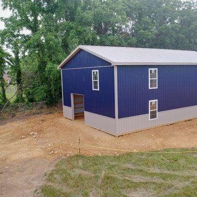 Dark blue and grey metal building package supplied by Ridgetop Roofing building supply store