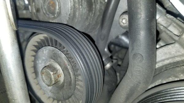 Bad tensioner pulley causing belt to wear improperly and possibly coming off.