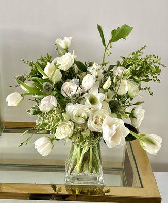 Green and white arrangement for private client sympathy.