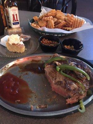 Wonderful stake with salad horseshoe fries corn bread beans and country corn.