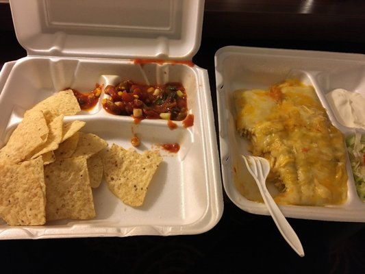 Chicken enchiladas with salsa and chips.