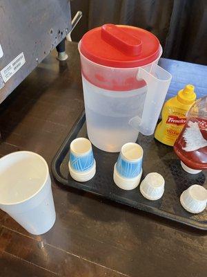 Smallest water cups next to a small cup