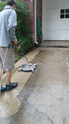 Power washing driveway with 16 inch surface cleaner.