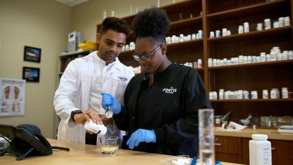 Pharmacy Tecnician students practicing in lab