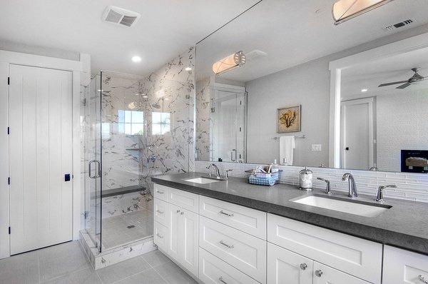 White cabinetry, Deep grey counter top & porcelain wall tile