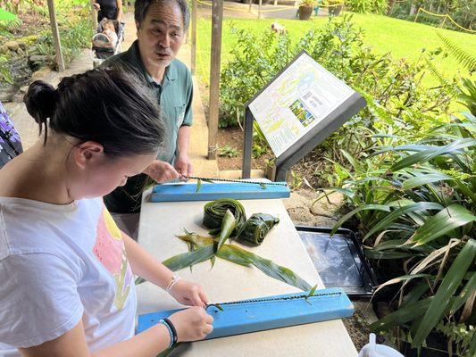 Making Ti leaf leis for Veterans Day