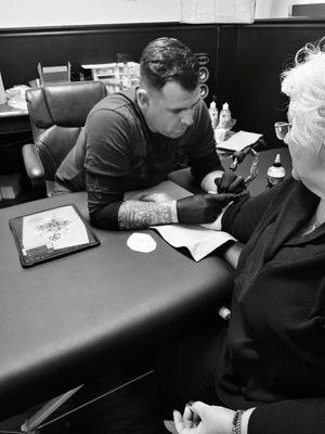 David tattooing my mom the next day same tat as mine.