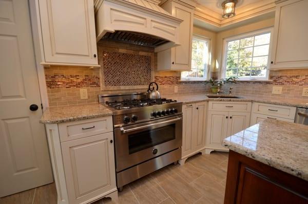 Beaded wood hood w/ beautiful mosaic tile-framed niche in the backsplash & custom frameless cabinetry. Wonderful!