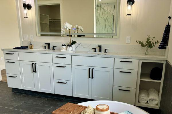 Master vanity with white maple shaker style cabinets.