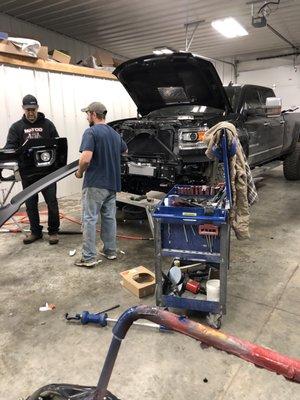 That's our truck getting fixed super fast, guy in the black hat is the owner he's super awesome and super cool guy he will take care of you