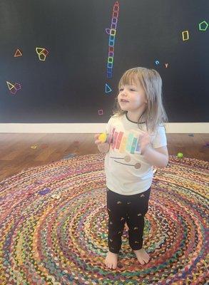 Lucy's favorite thing at Canny Kids is this colorful circle rug