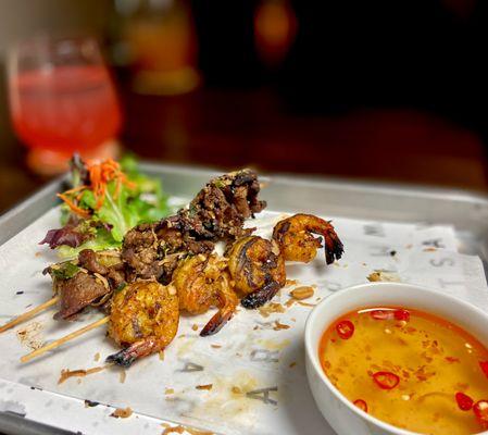 Grilled shrimp and grilled pork skewers, side of our signature lime fish sauce.