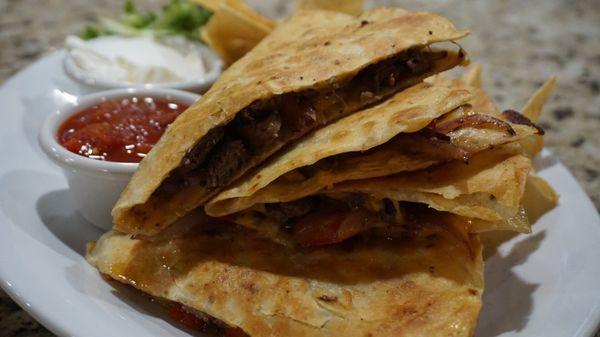 Steak Quesadilla with fresh, crunchy tortilla chips, salsa and a generous dollop of sour cream