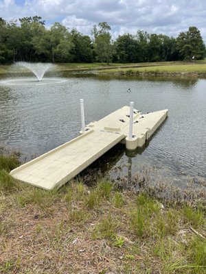 Our extra wide 280 jetski port with our polyramp laying on embankment shoreline