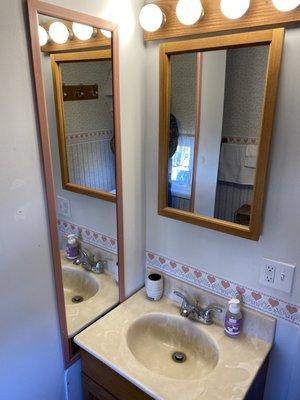 Full size bathroom with lots of mirrors