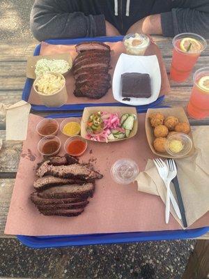 Brisket, with mac and cheese, coleslaw, hush puppies, banana pudding, chocolate brownie, and last strawberry lemonade.